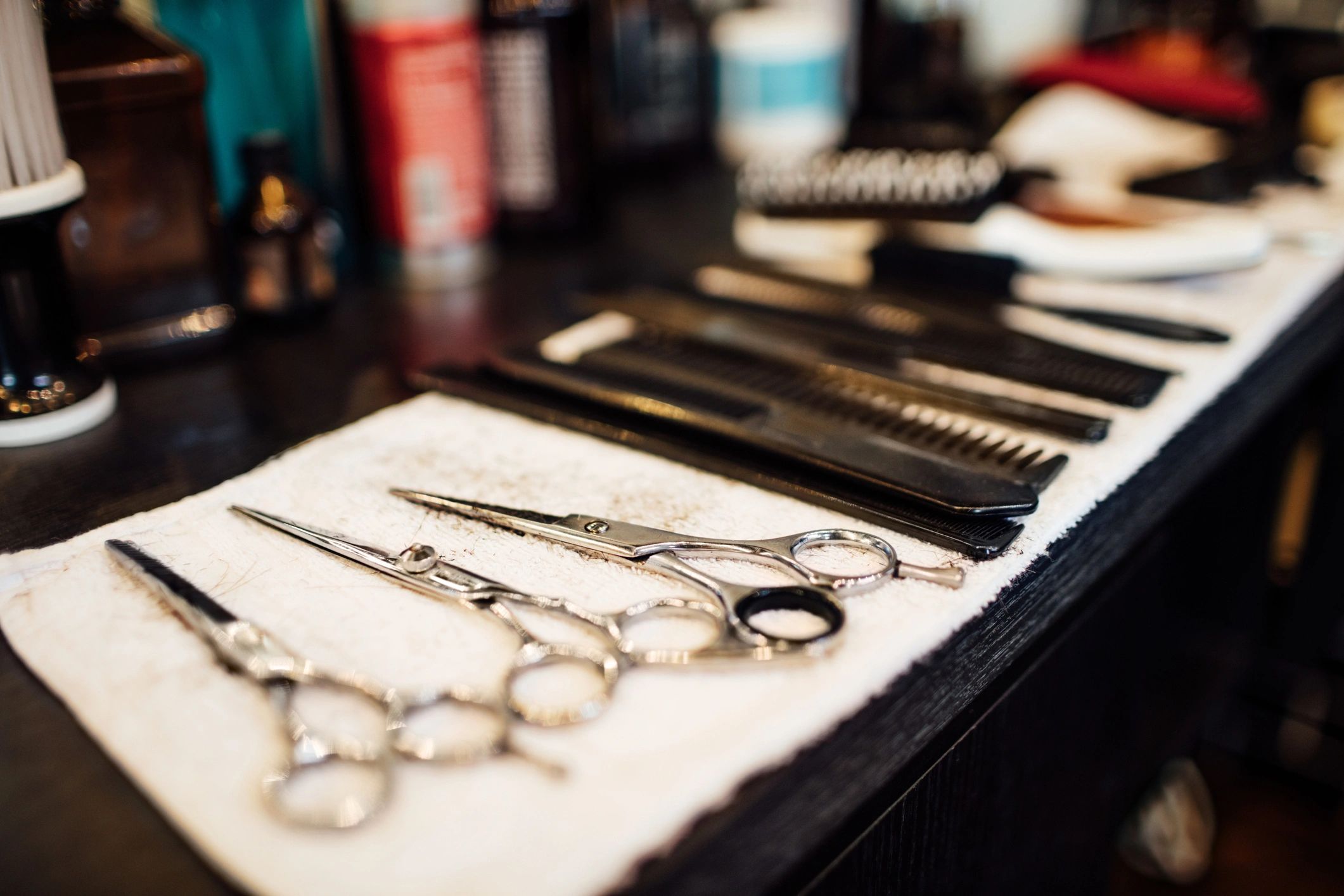 Haircutting scissors and combs arranged in a barbershop
