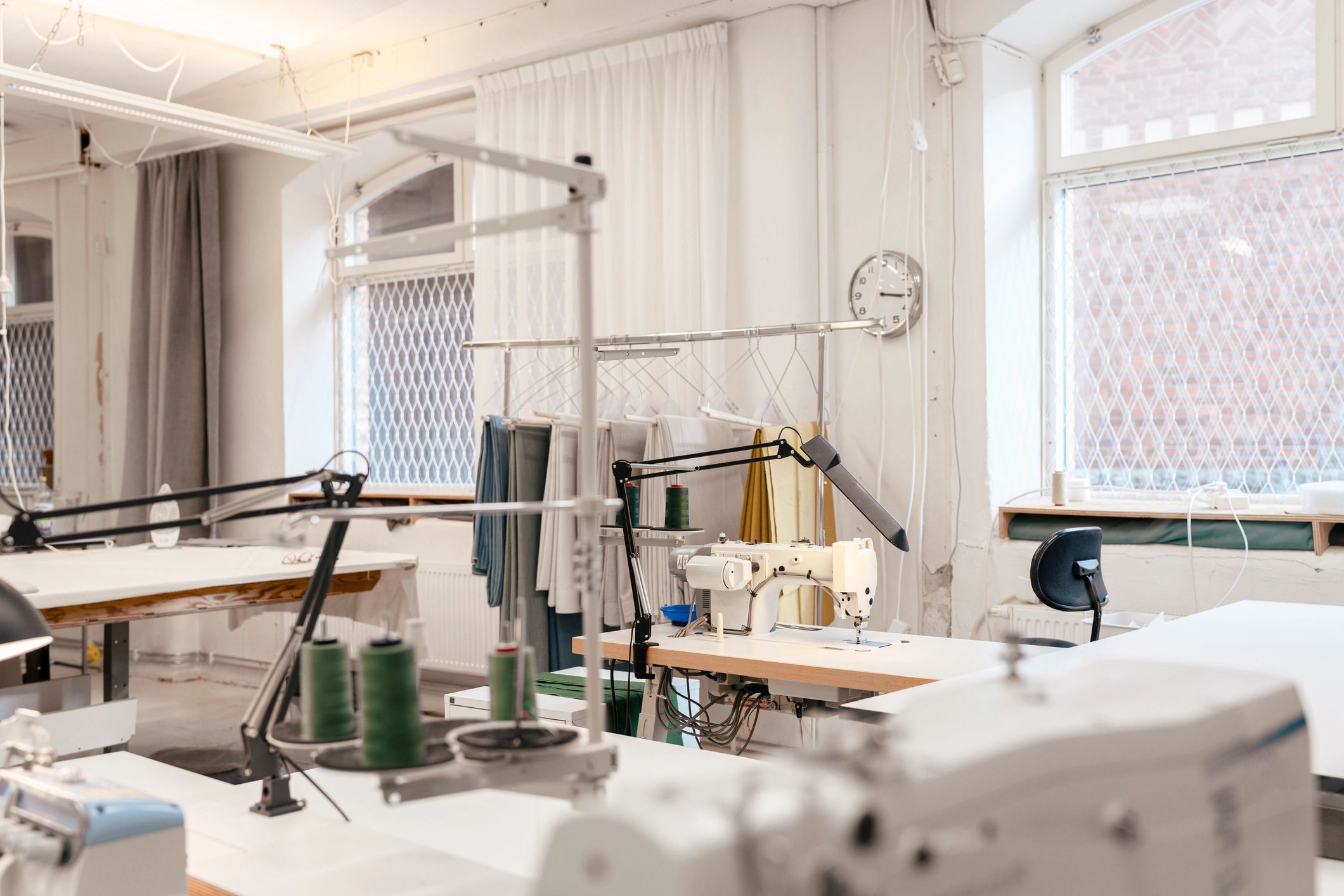Sewing workshop with fabric and cutting tables
