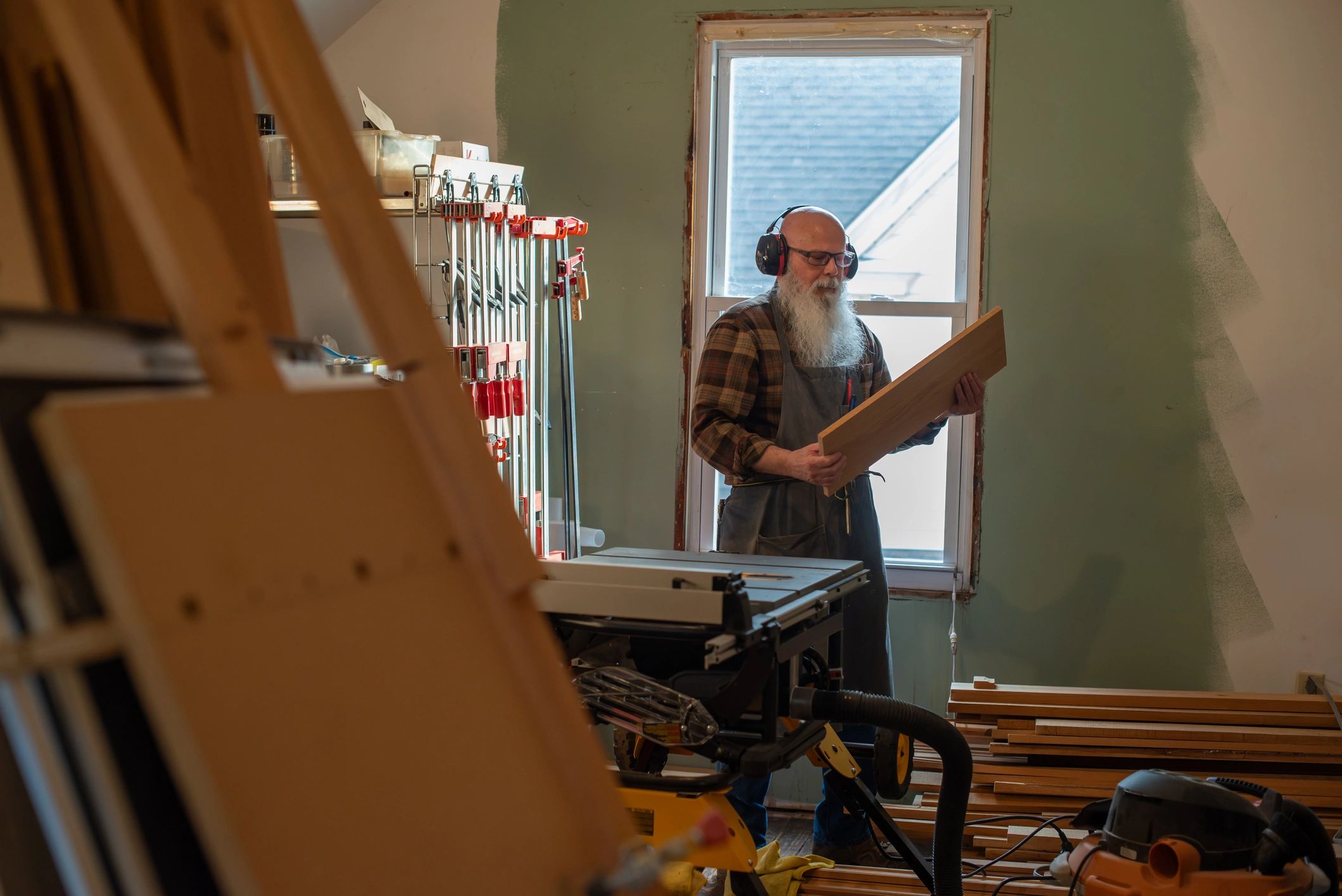 Woodworker inspecting lumber in a workshop